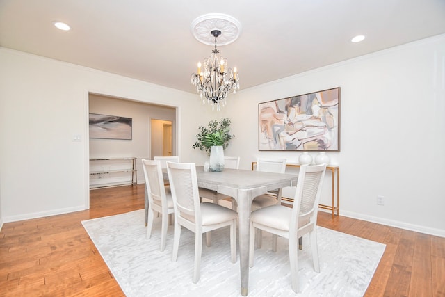 10035 Ella Lee Ln, Houston, TX 77042 - dining room featuring a chandelier, light wood-style floors, crown molding, and recessed lighting