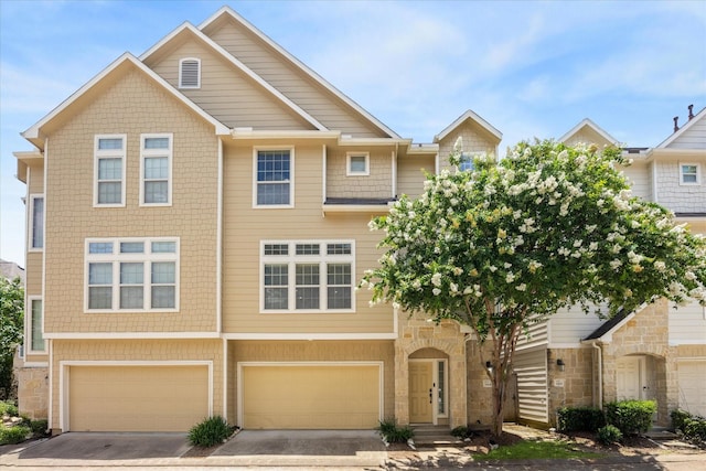 3324 Masters Point Dr, Houston, TX 77091 - view of property featuring an attached garage, driveway, and stone siding