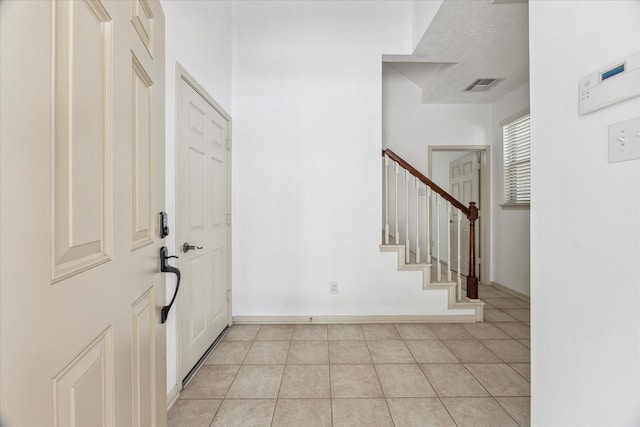 3324 Masters Point Dr, Houston, TX 77091 - entryway with light tile patterned floors and stairs