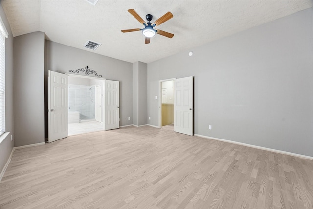 3324 Masters Point Dr, Houston, TX 77091 - unfurnished bedroom featuring light wood-style flooring, vaulted ceiling, ensuite bathroom, a textured ceiling, and ceiling fan