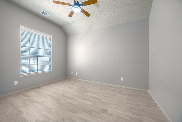3324 Masters Point Dr, Houston, TX 77091 - spare room with ceiling fan, a textured ceiling, light wood-style flooring, and vaulted ceiling