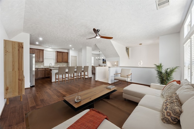 3324 Masters Point Dr, Houston, TX 77091 - living area with a ceiling fan, a textured ceiling, dark wood finished floors, and a chandelier