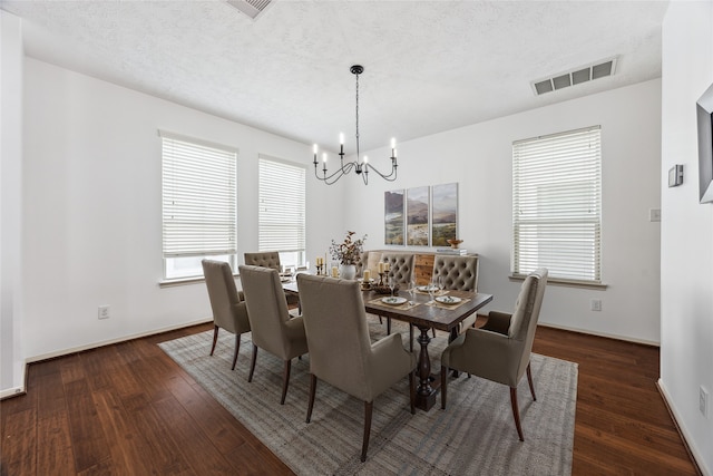 3324 Masters Point Dr, Houston, TX 77091 - dining area featuring a chandelier, wood finished floors, and a textured ceiling