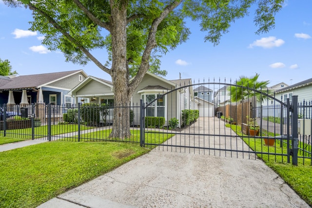 829 E 27th St, Houston, TX 77009 - view of front of property with concrete driveway, a gate, a fenced front yard, and a residential view