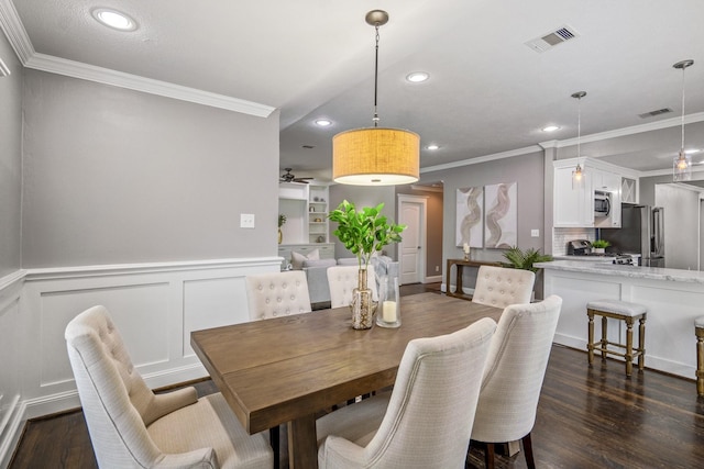 829 E 27th St, Houston, TX 77009 - dining space with ornamental molding, recessed lighting, dark wood finished floors, a wainscoted wall, and a ceiling fan