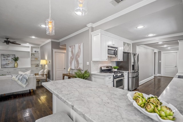 829 E 27th St, Houston, TX 77009 - kitchen with stainless steel appliances, white cabinets, dark wood-style floors, tasteful backsplash, and a ceiling fan