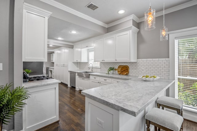 829 E 27th St, Houston, TX 77009 - kitchen with a peninsula, white cabinets, crown molding, decorative backsplash, and recessed lighting