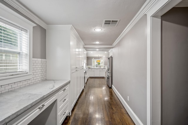829 E 27th St, Houston, TX 77009 - corridor with dark wood-type flooring, ornamental molding, a textured ceiling, and recessed lighting