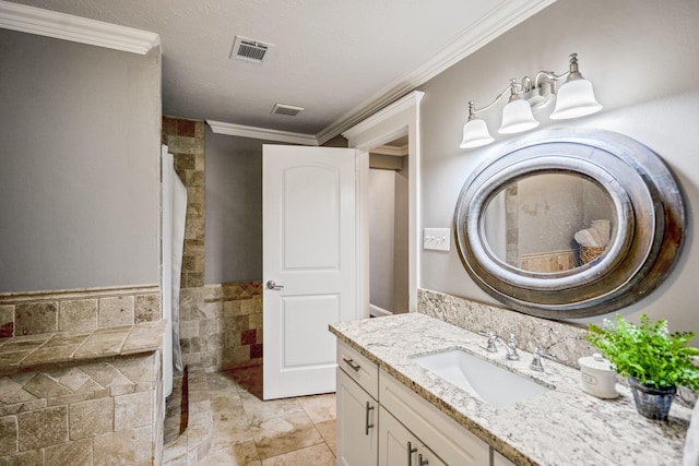 829 E 27th St, Houston, TX 77009 - bathroom featuring vanity, crown molding, wainscoting, and tile walls