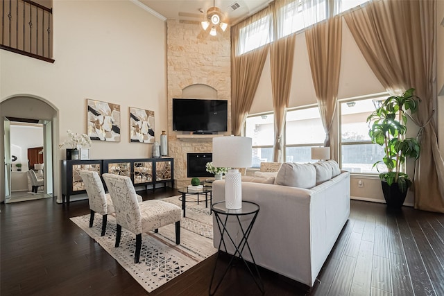 6022 Allendale Ridge Trl, Richmond, TX 77407 - living room featuring ceiling fan, a glass covered fireplace, dark wood-style floors, and ornamental molding