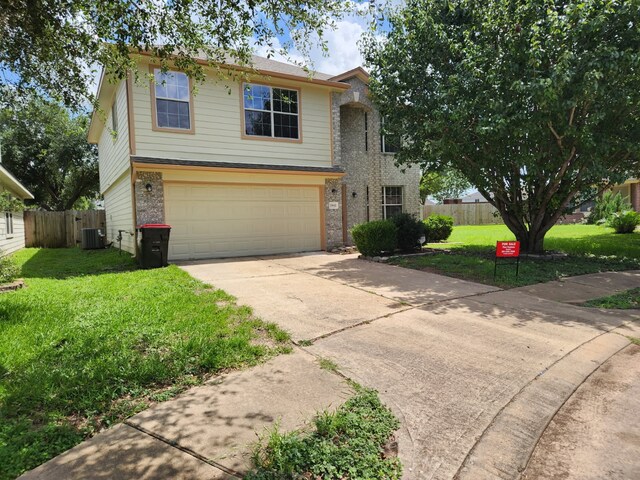 19843 Portlick Ct, Katy, TX 77449 - traditional-style house featuring brick siding, an attached garage, and concrete driveway
