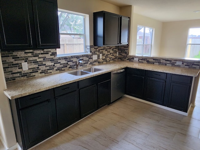 19843 Portlick Ct, Katy, TX 77449 - kitchen with dishwashing machine, backsplash, a peninsula, and dark cabinets