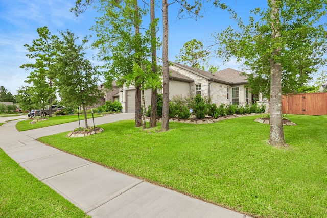 247 N Wild Petunia Trl, Montgomery, TX 77316 - view of front of house with stone siding, driveway, and a garage