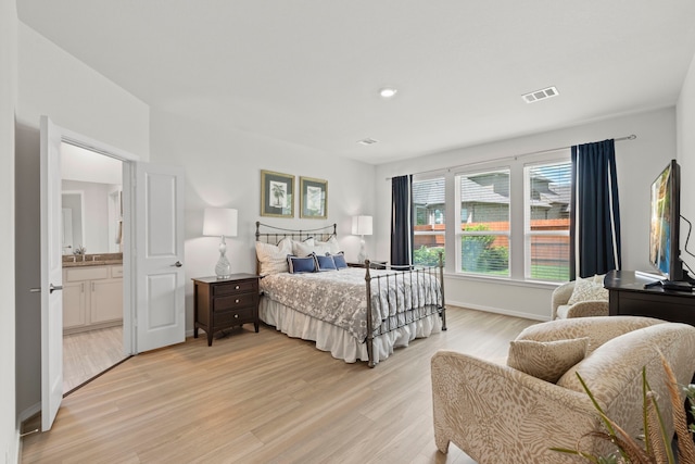 247 N Wild Petunia Trl, Montgomery, TX 77316 - bedroom with light wood-style floors and a sink