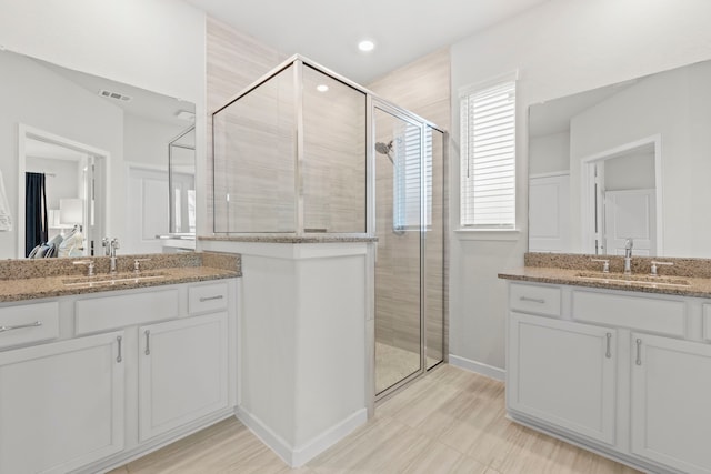 247 N Wild Petunia Trl, Montgomery, TX 77316 - bathroom featuring a shower stall, two vanities, connected bathroom, and recessed lighting