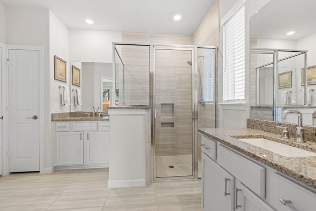 247 N Wild Petunia Trl, Montgomery, TX 77316 - bathroom with two vanities, a shower stall, and tile patterned floors