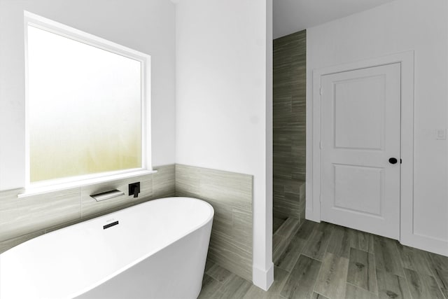 1005 Lake View Dr, Montgomery, TX 77356 - bathroom with tile walls and a freestanding bath