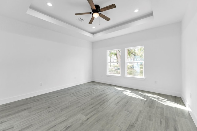 1005 Lake View Dr, Montgomery, TX 77356 - spare room featuring a tray ceiling, recessed lighting, ceiling fan, and light wood-type flooring