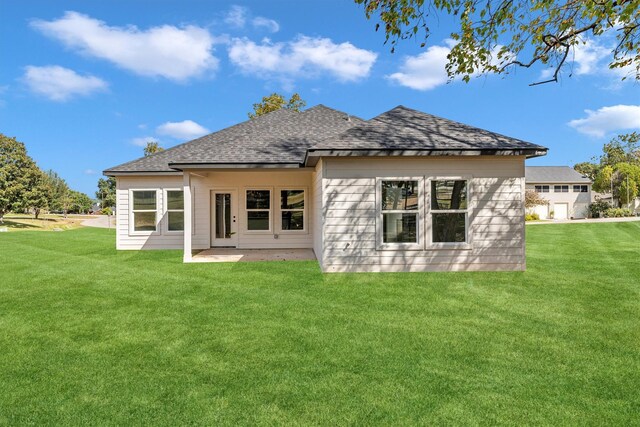 1005 Lake View Dr, Montgomery, TX 77356 - rear view of property with a shingled roof, a lawn, and a patio