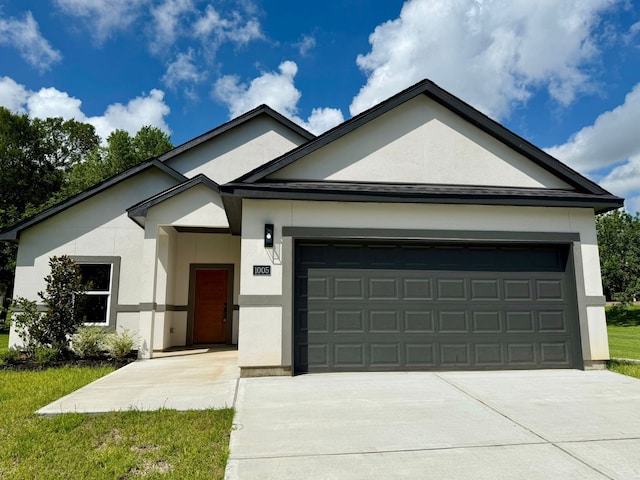 1005 Lake View Dr, Montgomery, TX 77356 - ranch-style house with stucco siding, an attached garage, and driveway
