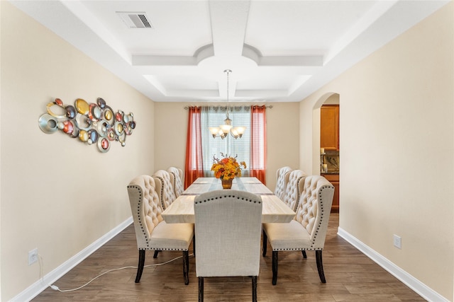 3614 Bonnie Bend Ln, Katy, TX 77494 - dining area with coffered ceiling, a chandelier, arched walkways, wood finished floors, and beamed ceiling