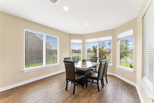 3614 Bonnie Bend Ln, Katy, TX 77494 - dining space with healthy amount of natural light, wood finished floors, recessed lighting, and a water view
