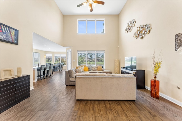 3614 Bonnie Bend Ln, Katy, TX 77494 - living area with ceiling fan, wood finished floors, and a towering ceiling