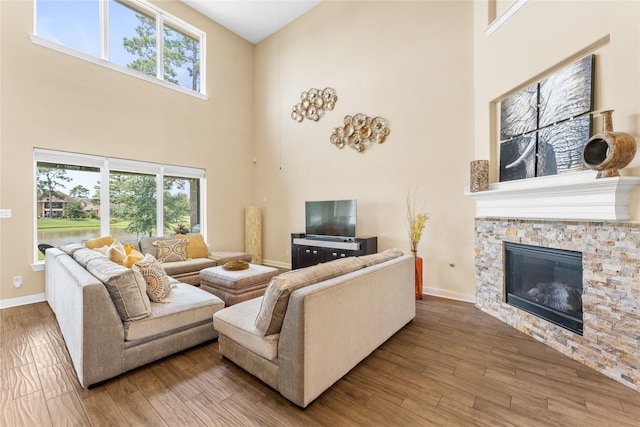 3614 Bonnie Bend Ln, Katy, TX 77494 - living room with a towering ceiling, a fireplace, and wood finished floors