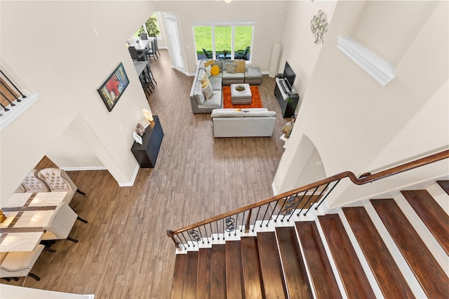 3614 Bonnie Bend Ln, Katy, TX 77494 - stairs with wood finished floors and a towering ceiling