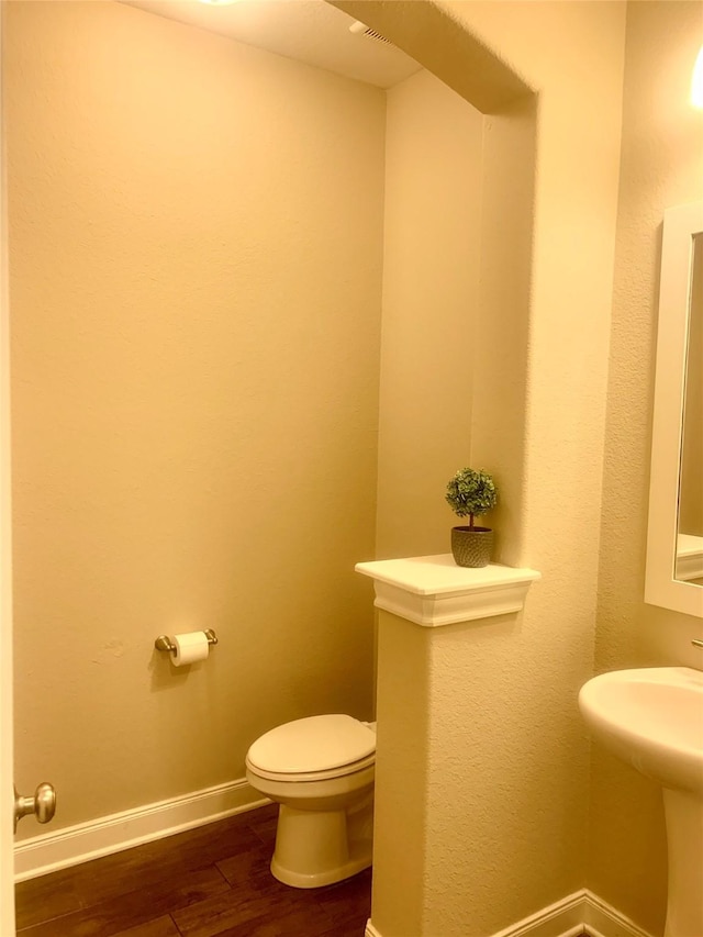 3614 Bonnie Bend Ln, Katy, TX 77494 - half bathroom featuring wood finished floors and toilet
