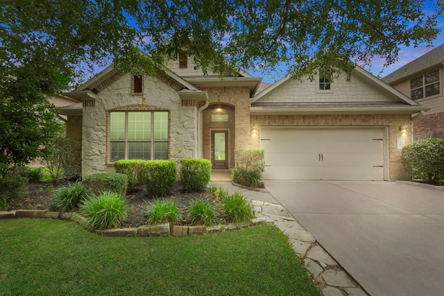 1109 Jacobs Lake Blvd, Conroe, TX 77384 - view of front of home featuring an attached garage, driveway, stone siding, and a front yard