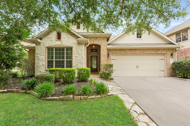 1109 Jacobs Lake Blvd, Conroe, TX 77384 - view of front of house with stone siding, driveway, an attached garage, and a front lawn