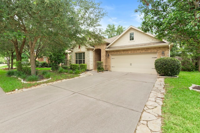 1109 Jacobs Lake Blvd, Conroe, TX 77384 - view of front of house with driveway, a garage, a front lawn, and brick siding