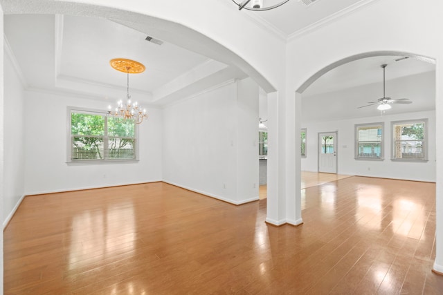 1109 Jacobs Lake Blvd, Conroe, TX 77384 - unfurnished room featuring arched walkways, plenty of natural light, a chandelier, wood finished floors, and ornamental molding
