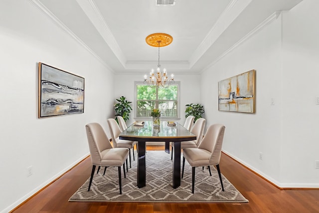1109 Jacobs Lake Blvd, Conroe, TX 77384 - dining area featuring a chandelier, wood finished floors, a tray ceiling, and ornamental molding