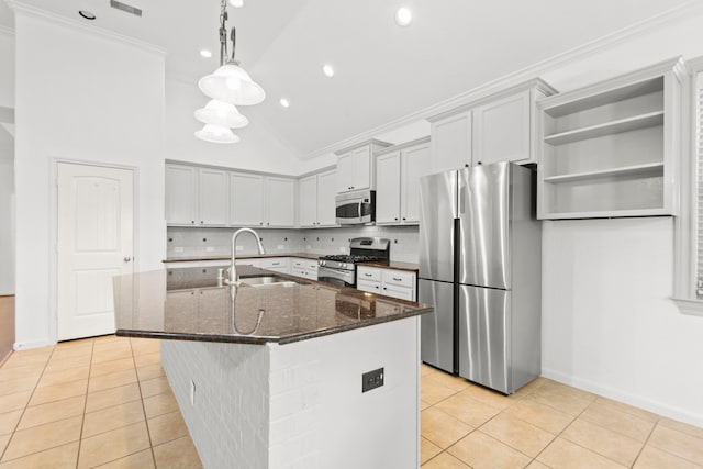 1109 Jacobs Lake Blvd, Conroe, TX 77384 - kitchen with stainless steel appliances, light tile patterned floors, tasteful backsplash, dark stone countertops, and crown molding