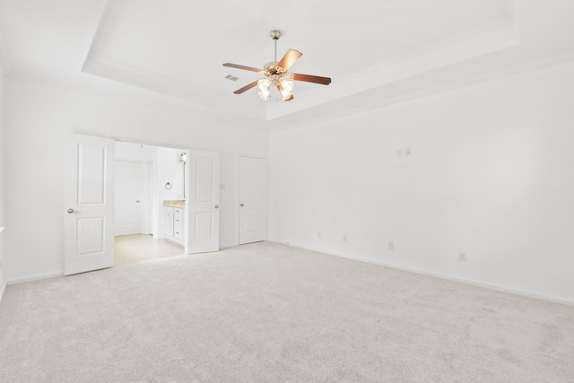 1109 Jacobs Lake Blvd, Conroe, TX 77384 - unfurnished bedroom featuring a raised ceiling, light carpet, crown molding, ensuite bathroom, and a ceiling fan