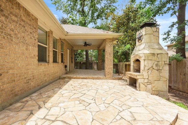 1109 Jacobs Lake Blvd, Conroe, TX 77384 - fenced backyard with a fireplace, ceiling fan, and a patio area
