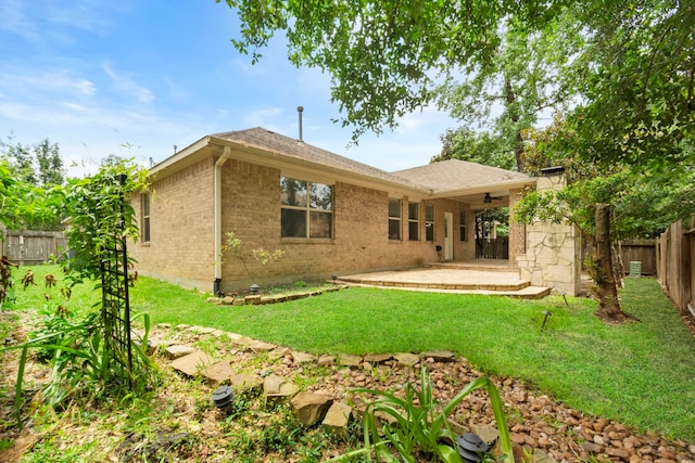 1109 Jacobs Lake Blvd, Conroe, TX 77384 - rear view of property with ceiling fan, a fenced backyard, brick siding, roof with shingles, and a patio area