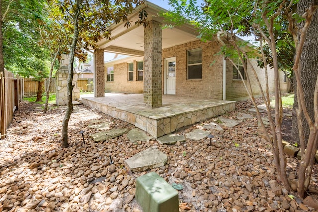 1109 Jacobs Lake Blvd, Conroe, TX 77384 - back of property featuring a fenced backyard and brick siding