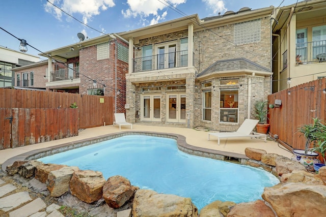 5346 Mcculloch Cir, Houston, TX 77056 - back of house with french doors, a balcony, a fenced backyard, and a patio area
