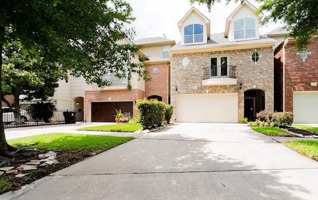 5346 Mcculloch Cir, Houston, TX 77056 - view of front of house featuring a balcony, an attached garage, concrete driveway, and brick siding