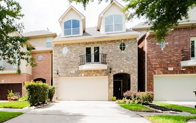 5346 Mcculloch Cir, Houston, TX 77056 - view of front of house featuring a balcony, a garage, driveway, and brick siding