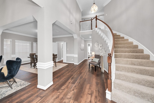 8618 Aldeburgh Ct, Spring, TX 77379 - foyer featuring a high ceiling, stairs, dark wood finished floors, ornamental molding, and a chandelier