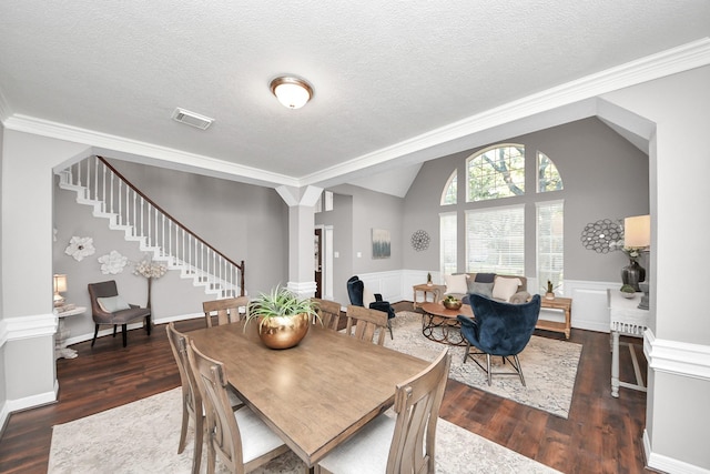 8618 Aldeburgh Ct, Spring, TX 77379 - dining space with stairs, wood finished floors, crown molding, wainscoting, and a textured ceiling