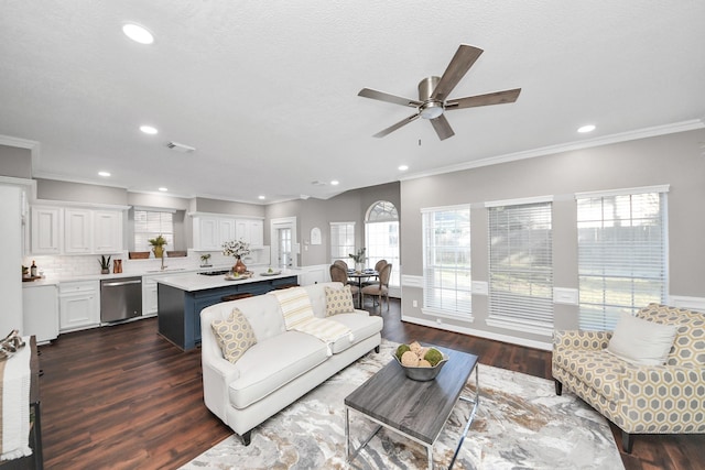 8618 Aldeburgh Ct, Spring, TX 77379 - living area with plenty of natural light, ceiling fan, dark wood finished floors, ornamental molding, and recessed lighting