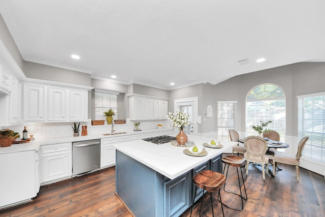 8618 Aldeburgh Ct, Spring, TX 77379 - kitchen with stainless steel appliances, white cabinets, light countertops, a kitchen breakfast bar, and a kitchen island