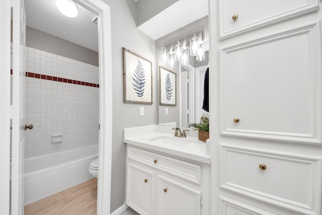 8618 Aldeburgh Ct, Spring, TX 77379 - bathroom with vanity, tub / shower combination, and wood finished floors
