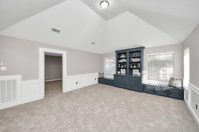 8618 Aldeburgh Ct, Spring, TX 77379 - carpeted empty room featuring wainscoting, high vaulted ceiling, and a decorative wall