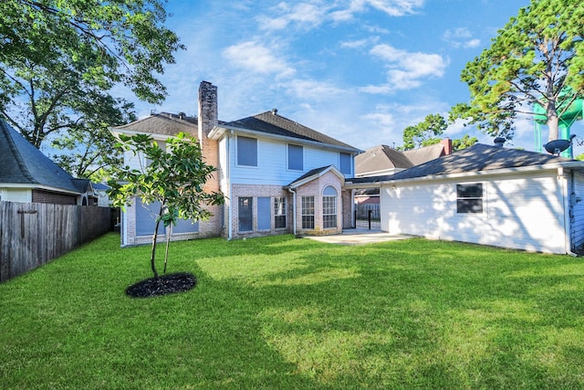 8618 Aldeburgh Ct, Spring, TX 77379 - back of property with a patio area, a chimney, and brick siding